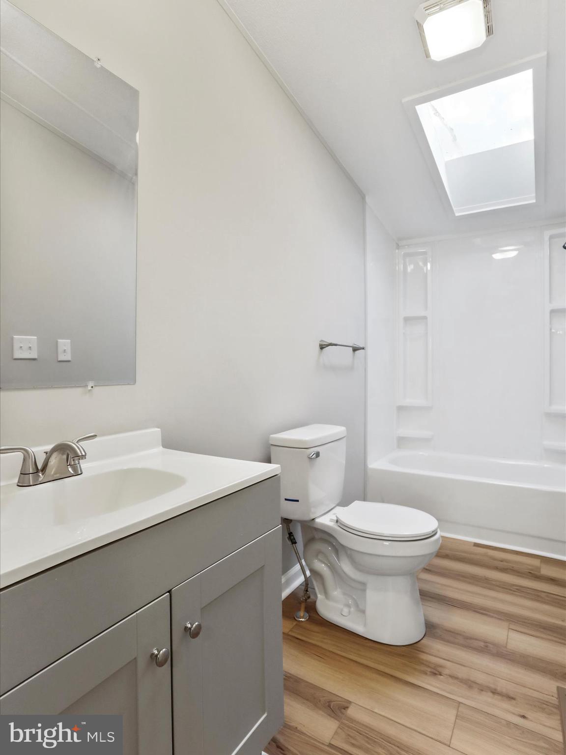 156 Potomacview Lane Berkeley Springs, WV 25411 - Photo 20 of 27 a bathroom with a sink toilet a mirror and vanity