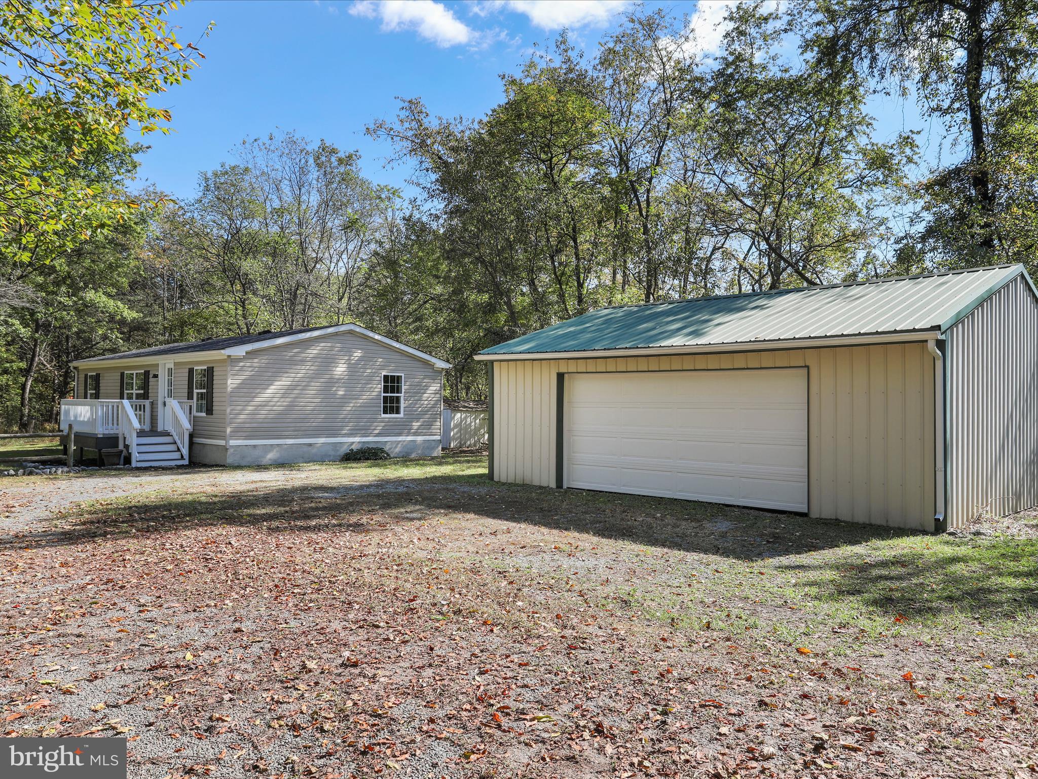 156 Potomacview Lane Berkeley Springs, WV 25411 - Photo 2 of 27 a view of a house with backyard and trees