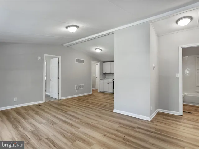 a view of kitchen with wooden floor electronic appliances and window