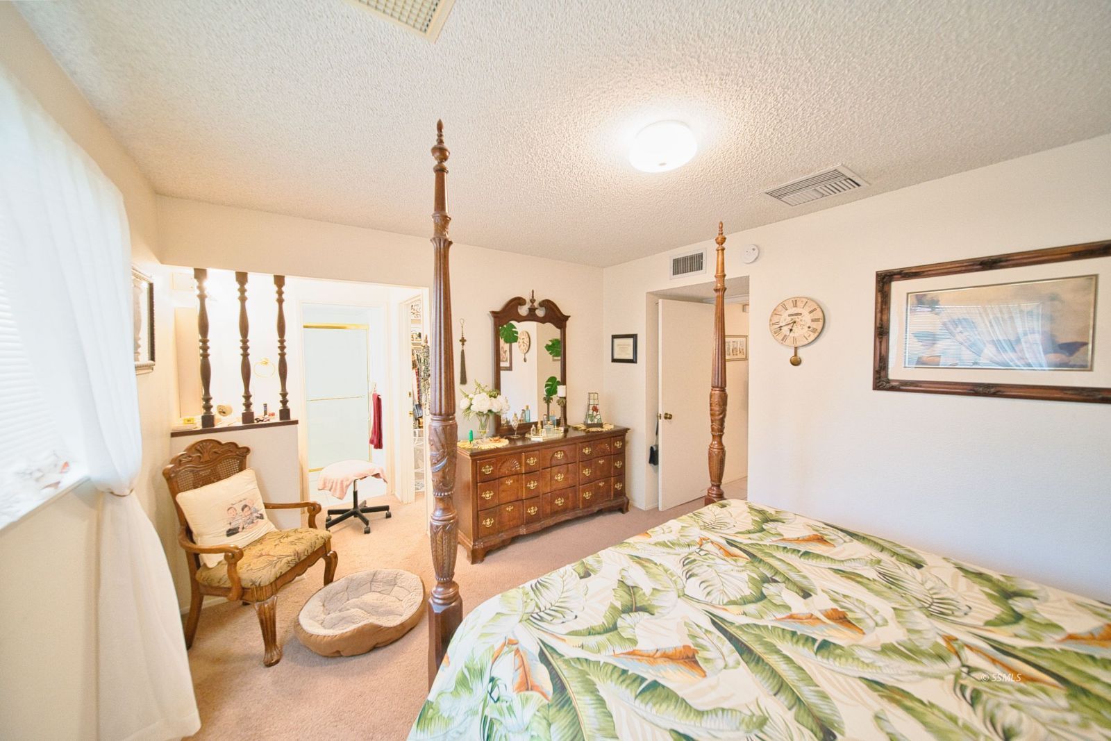 1024 Sherri Street Ridgecrest, CA 93555 - Photo 24 of 41 a bedroom with a bed and a chandelier