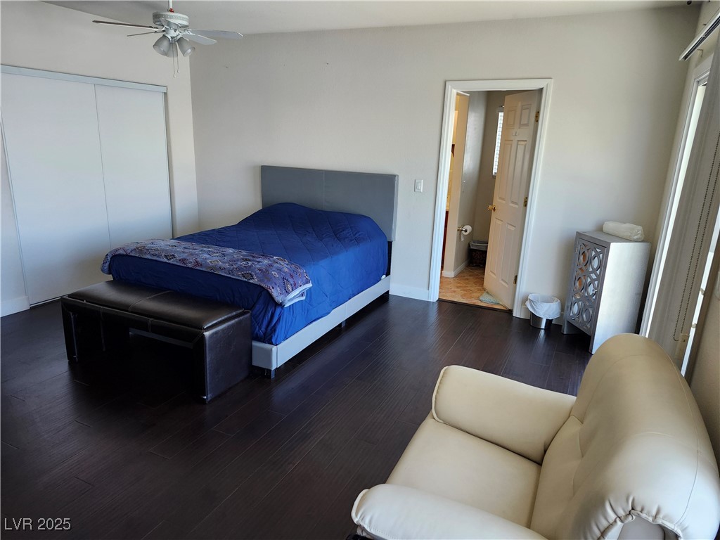 6672 Coronado Palms Avenue Las Vegas, NV 89139 - Photo 15 of 39 Bedroom with wood finished floors, a closet, baseb