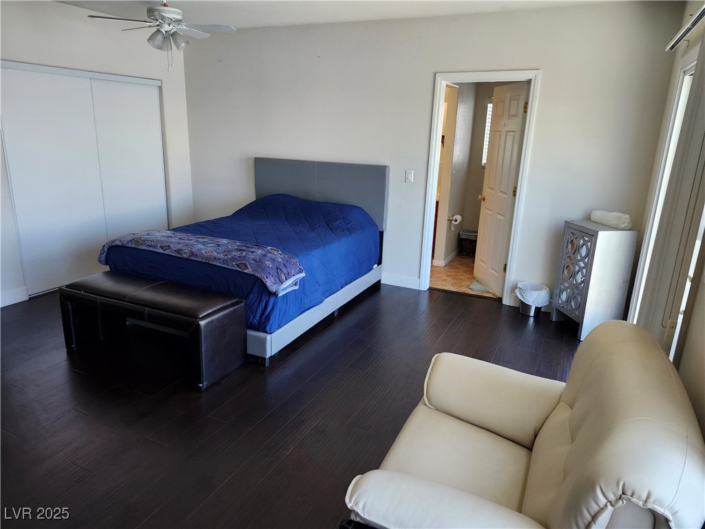 6672 Coronado Palms Avenue Las Vegas, NV 89139 - Photo 16 of 39 Bedroom with wood finished floors, a closet, baseb