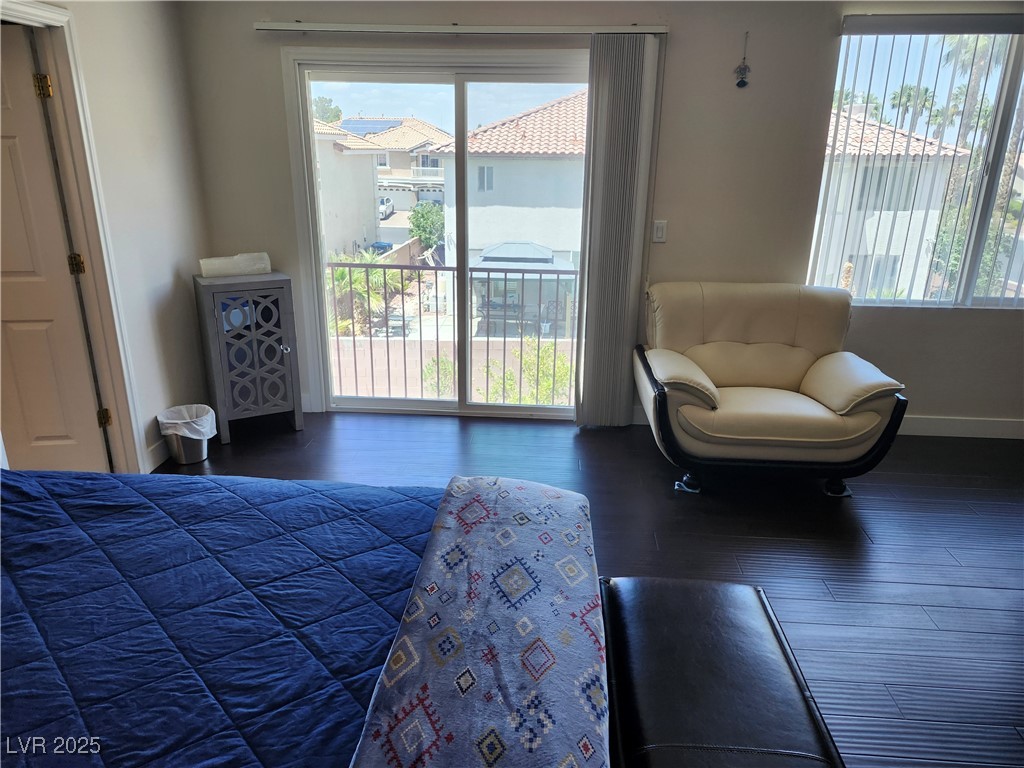 6672 Coronado Palms Avenue Las Vegas, NV 89139 - Photo 21 of 39 Bedroom with access to outside, wood finished floo