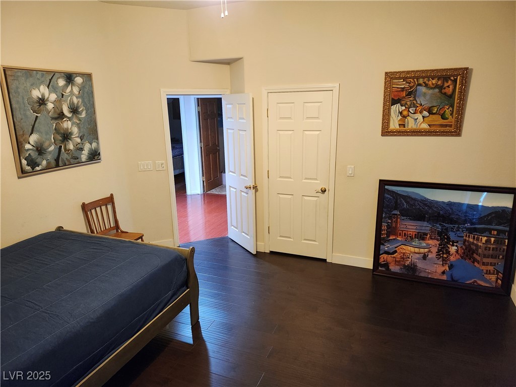 6672 Coronado Palms Avenue Las Vegas, NV 89139 - Photo 26 of 39 Bedroom with dark wood-type flooring, baseboards,