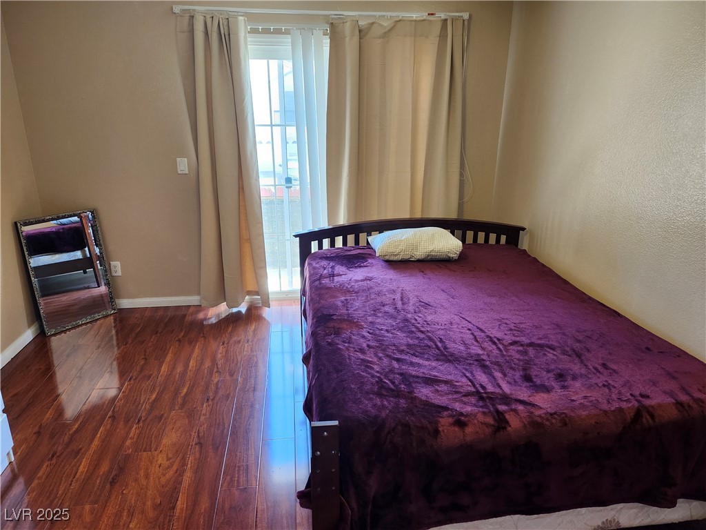 6672 Coronado Palms Avenue Las Vegas, NV 89139 - Photo 33 of 39 Bedroom with dark wood-style floors and baseboards