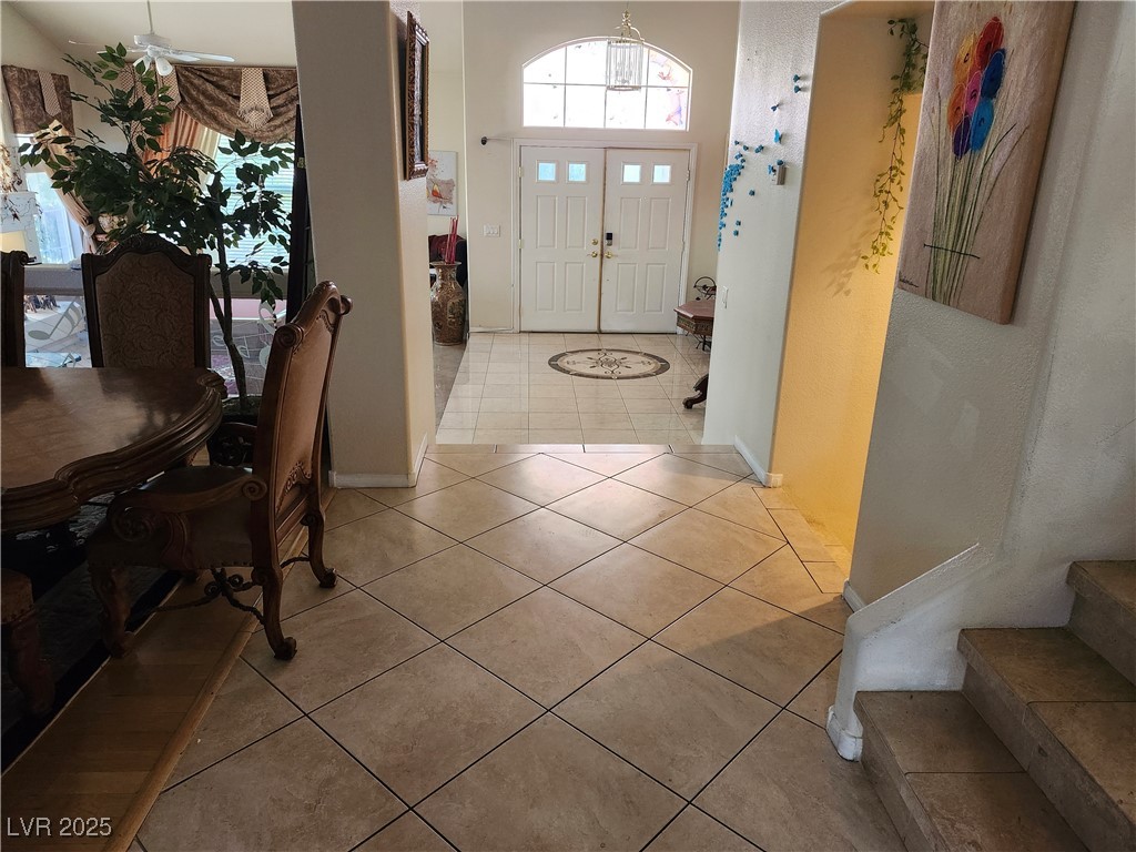 6672 Coronado Palms Avenue Las Vegas, NV 89139 - Photo 6 of 39 Tiled foyer with stairs and baseboards