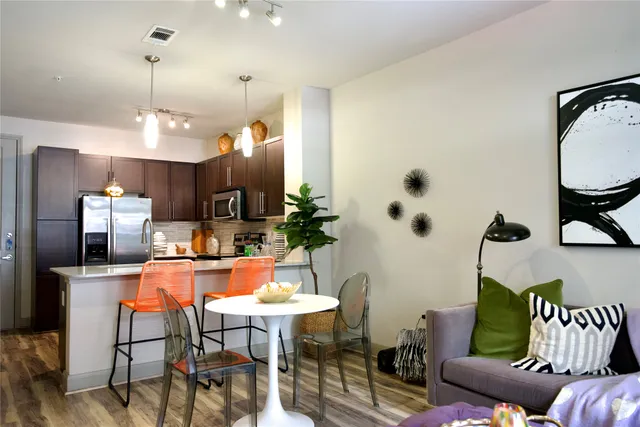 a dining room with furniture and wooden floor