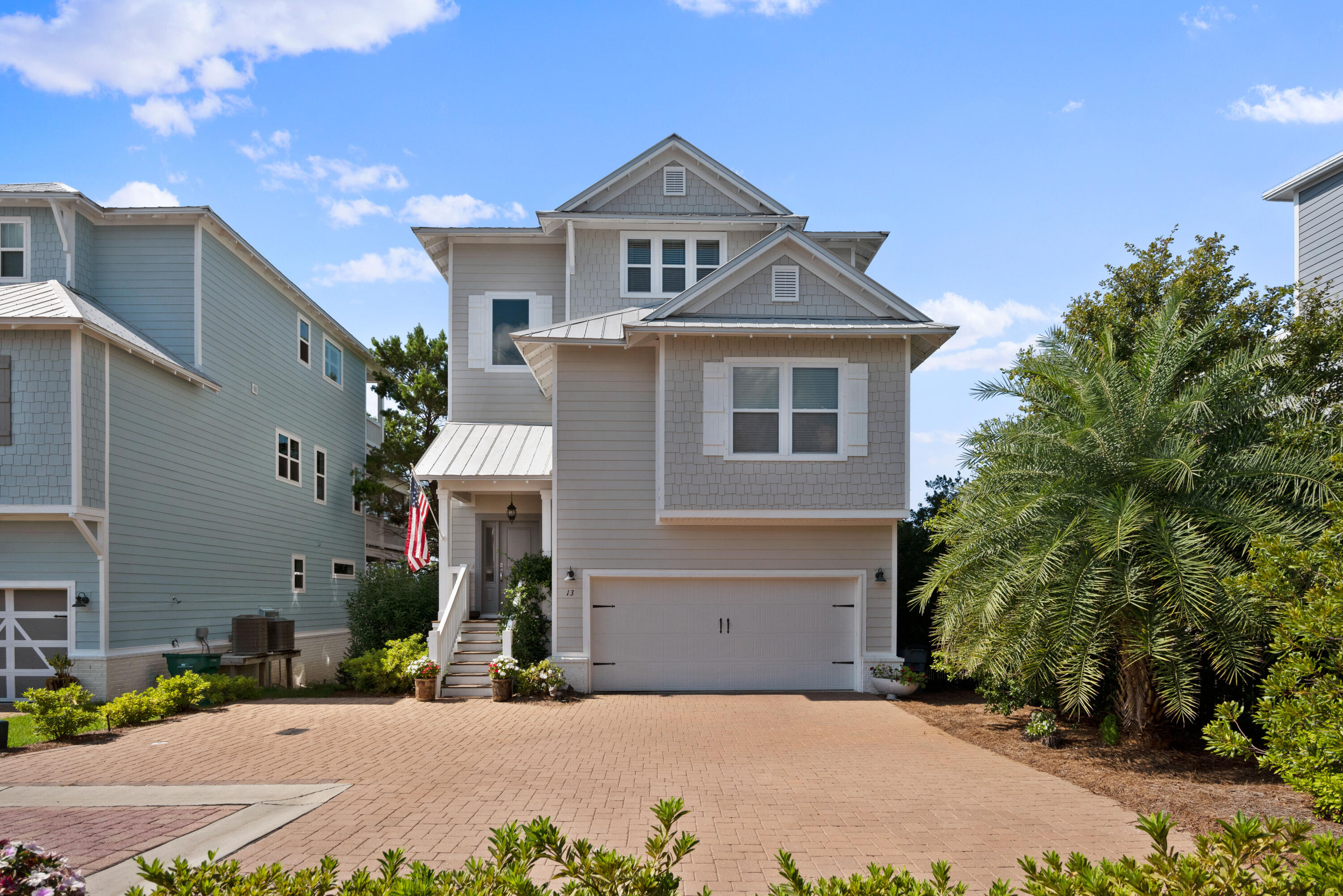 13 Inlet Cove Inlet Beach, FL 32461 - Photo 6 of 49 a front view of a house with a yard and garage
