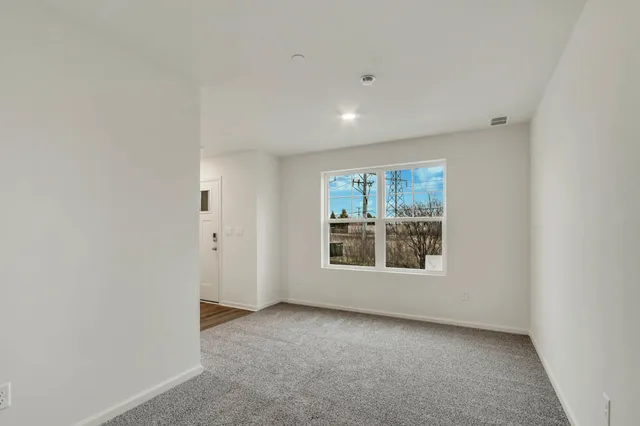 an empty room with windows and closet