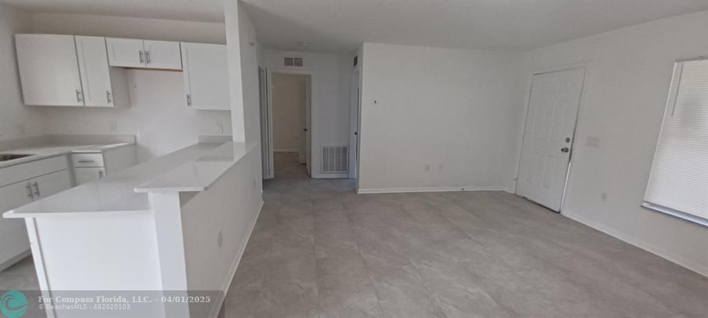 1410 Southeast 7th Street Okeechobee, FL 34974 - Photo 2 of 22 a kitchen with a sink a refrigerator and cabinets