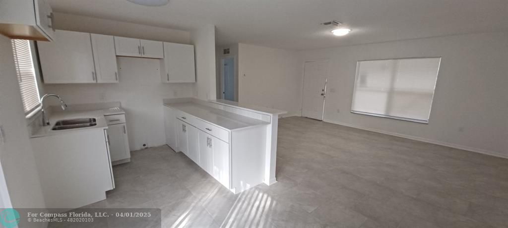 1410 Southeast 7th Street Okeechobee, FL 34974 - Photo 22 of 22 a view of a kitchen with white cabinets