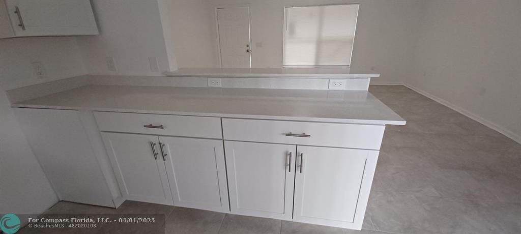 1410 Southeast 7th Street Okeechobee, FL 34974 - Photo 3 of 22 a view of white cabinets