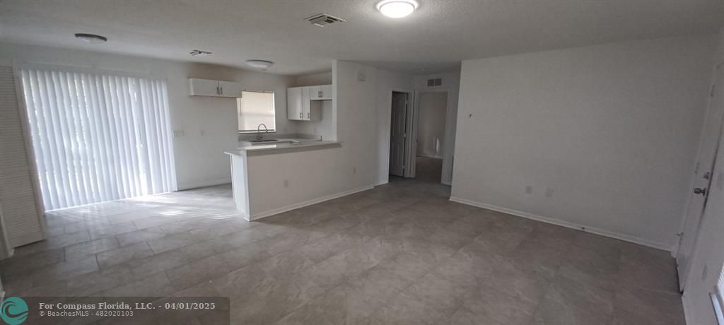 1410 Southeast 7th Street Okeechobee, FL 34974 - Photo 4 of 22 a view of a kitchen with a sink cabinets and a window