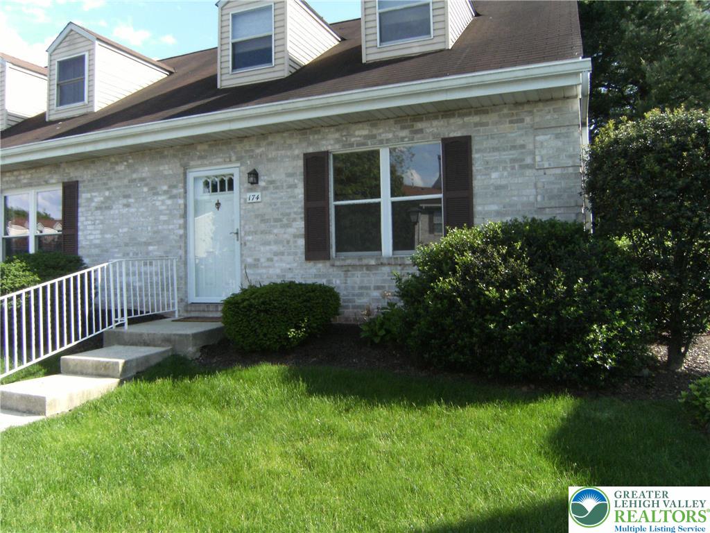 174 Springhouse Road Allentown, PA 18104 - Photo 2 of 10 a view of a brick house with a yard and a large tree