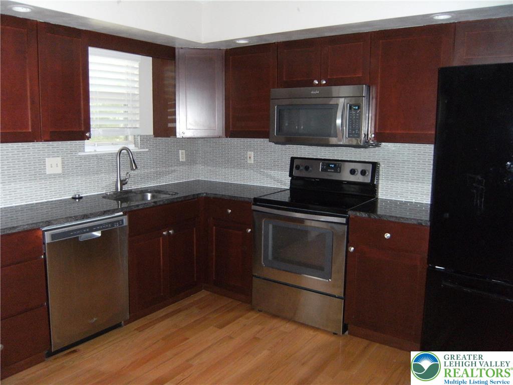 174 Springhouse Road Allentown, PA 18104 - Photo 5 of 10 a kitchen with a sink stove and microwave