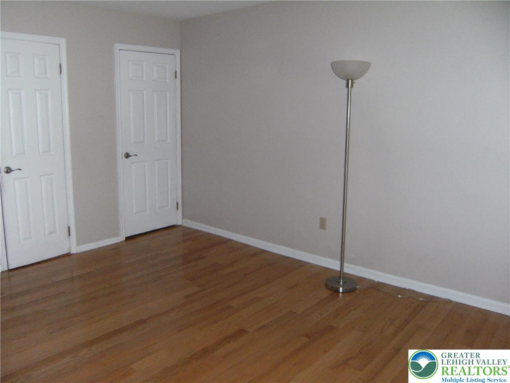 174 Springhouse Road Allentown, PA 18104 - Photo 6 of 10 a view of an empty room with wooden floor