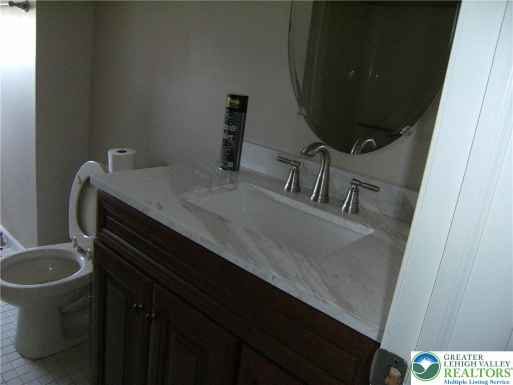 174 Springhouse Road Allentown, PA 18104 - Photo 7 of 10 a bathroom with a sink and a mirror