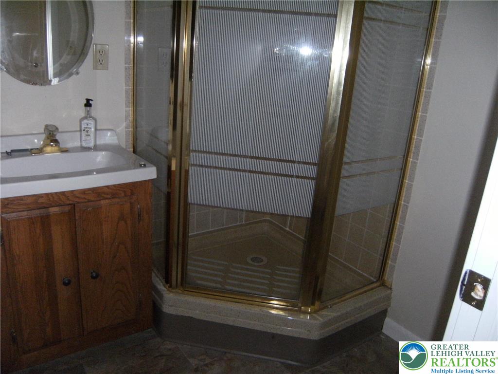 174 Springhouse Road Allentown, PA 18104 - Photo 9 of 10 a bathroom with a mirror and a shower