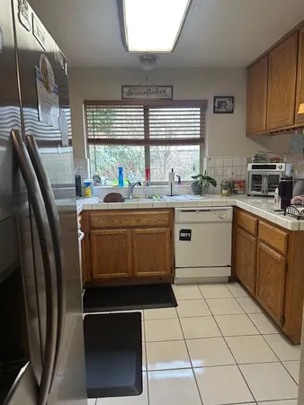 a kitchen with stainless steel appliances a stove a sink and a refrigerator