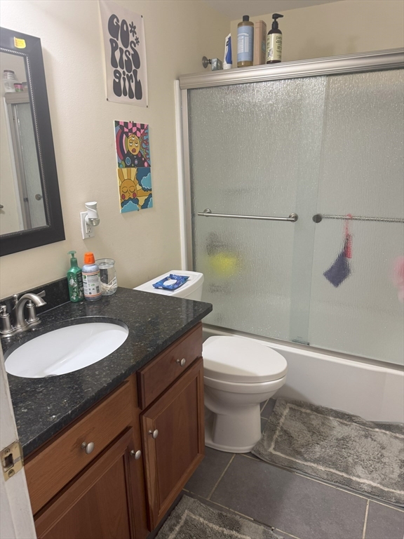200 Manning Street, Unit 14B Hudson, MA 01749 - Photo 7 of 9 a bathroom with a granite countertop sink toilet and a mirror