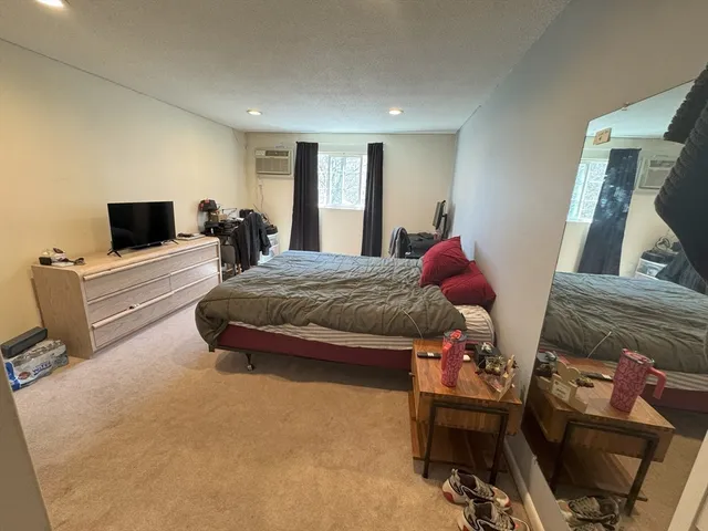 a bedroom with a bed and flat screen tv