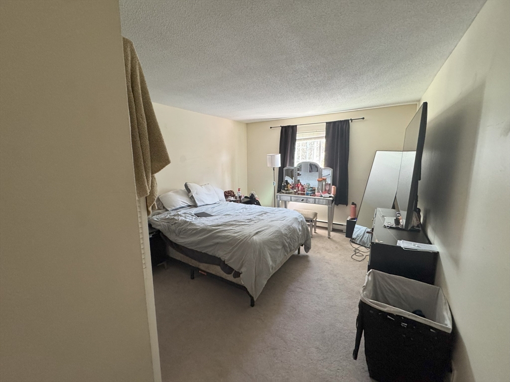 200 Manning Street, Unit 14B Hudson, MA 01749 - Photo 9 of 9 a bedroom with a bed window and couch