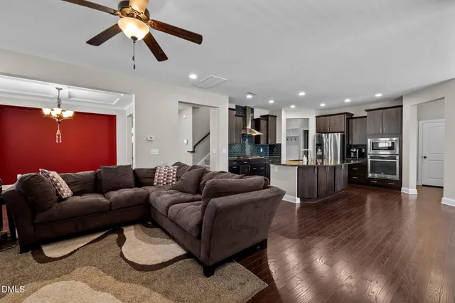 a kitchen with stainless steel appliances granite countertop a refrigerator a sink and a stove