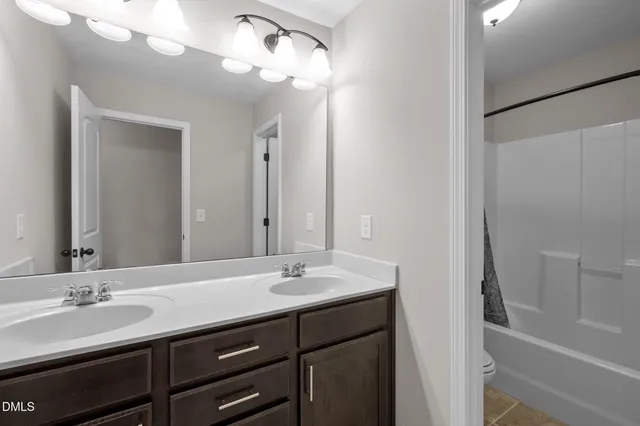 a view of a hallway with wooden floor and a livingroom view