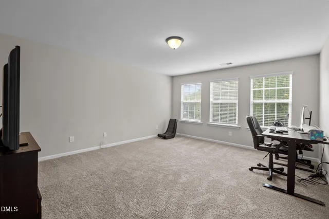 a bed room with a bed and a chair