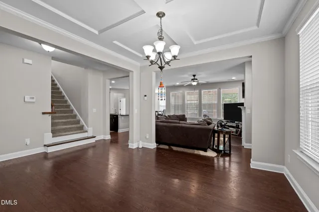 a living room with furniture a fireplace and a large window