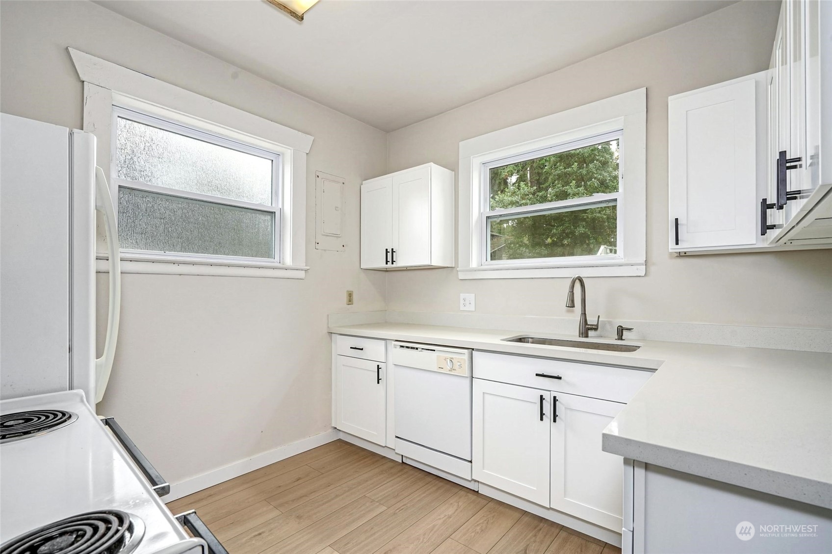 6344 37th Avenue Southwest Seattle, WA 98126 - Photo 7 of 20 a kitchen with a sink cabinets and a window