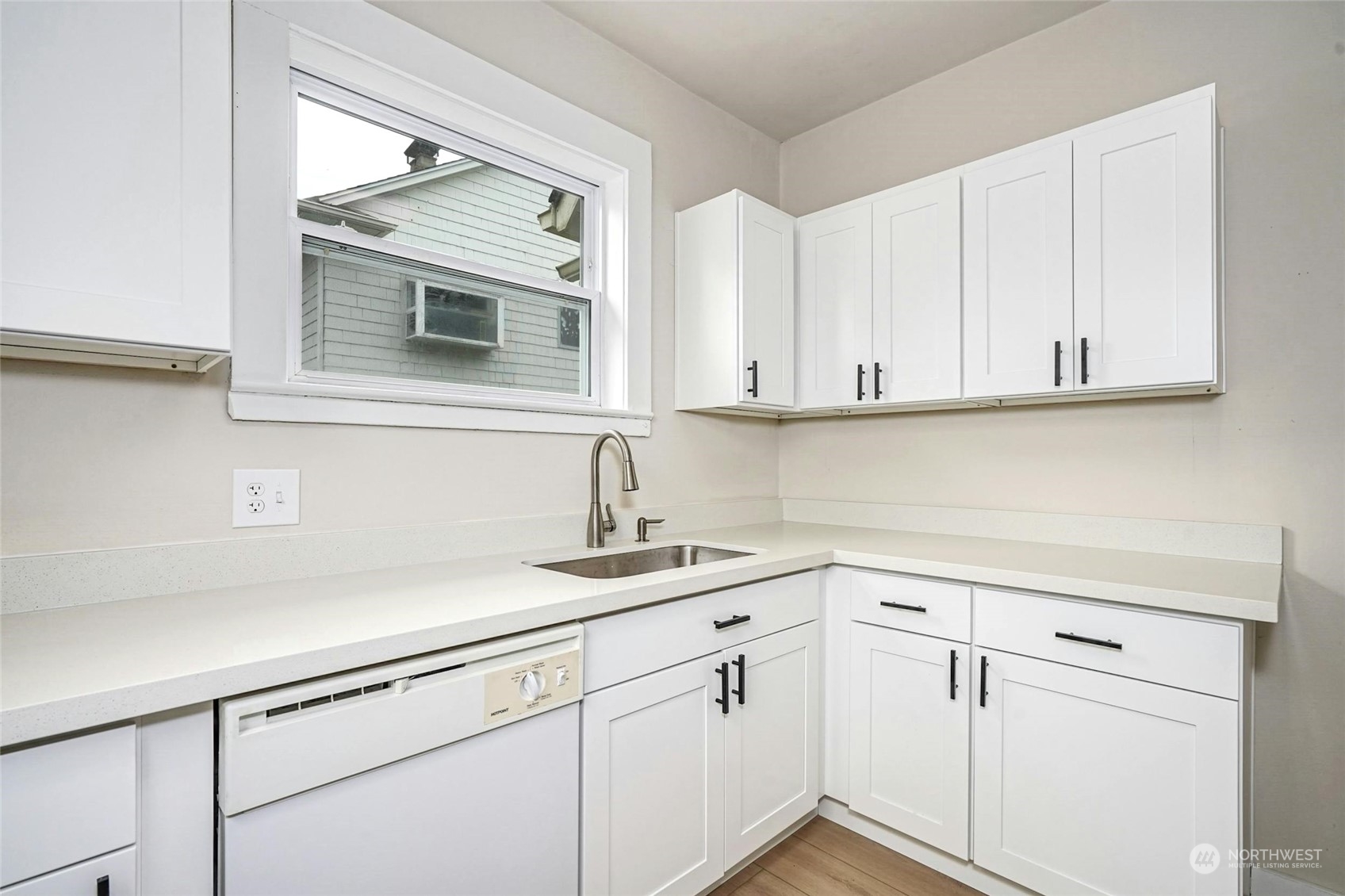 6344 37th Avenue Southwest Seattle, WA 98126 - Photo 8 of 20 a kitchen with stainless steel appliances white cabinets and a sink