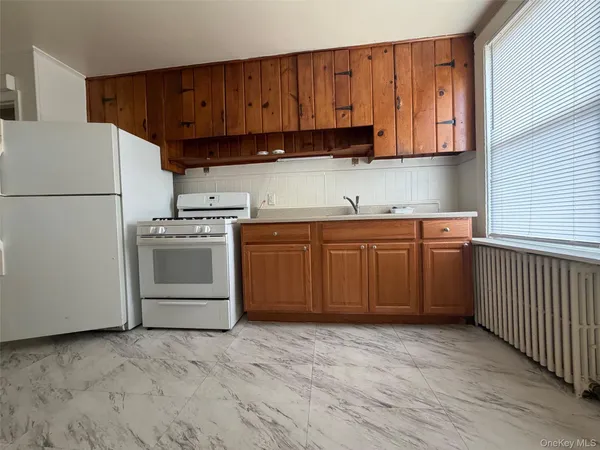 a kitchen with stainless steel appliances granite countertop a stove a sink dishwasher and a refrigerator