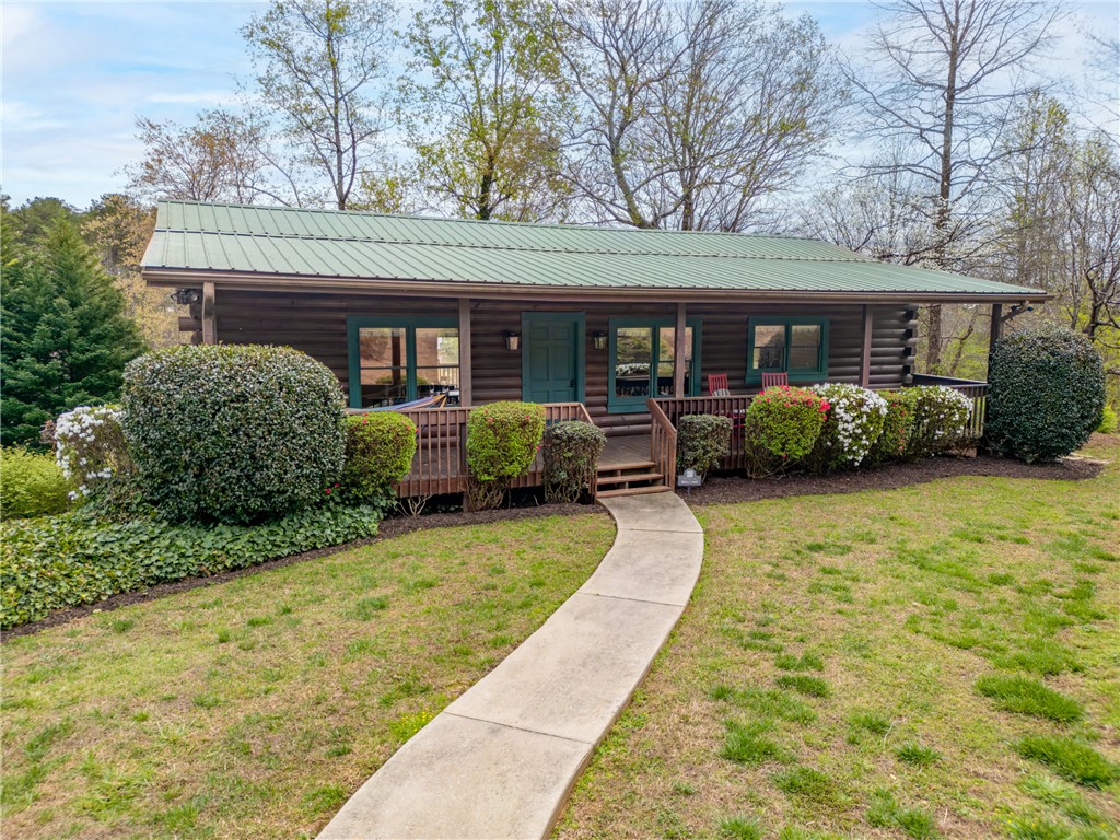 203 Little Lane Seneca, SC 29672 - Photo 1 of 48 This charming cabin home features a welcoming porch, lush landscaping, and a scenic natural setting.