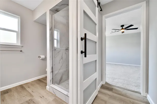 a spacious bedroom with a bed couch and window