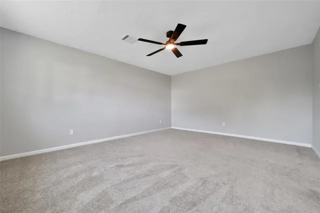 a bathroom with a granite countertop double vanity sink a mirror and a toilet