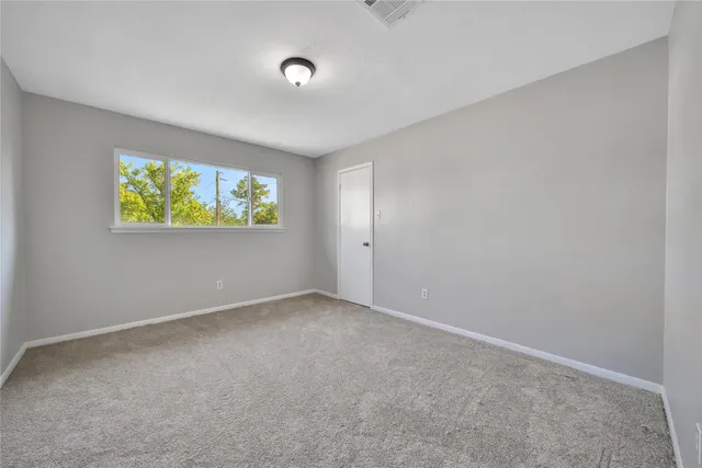 a bedroom with bed and a window