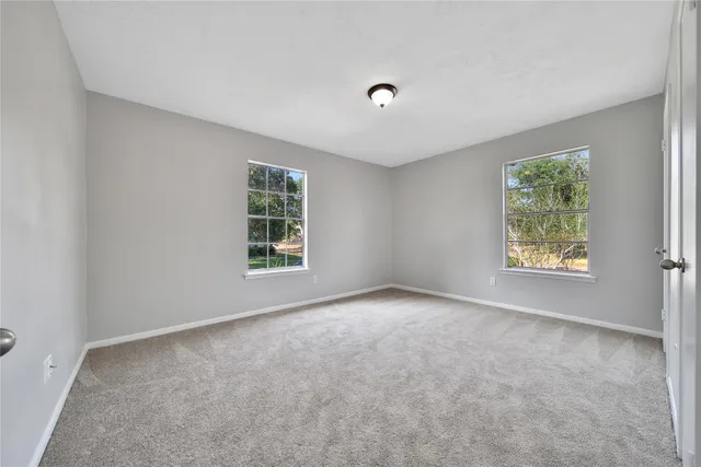 a spacious bedroom with a bed and a window