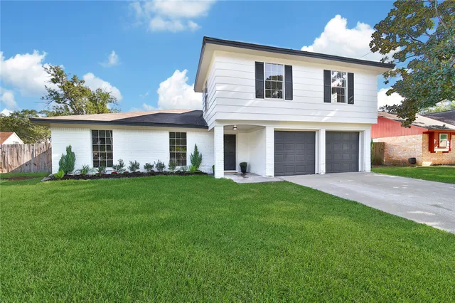 a front view of house with yard and green space