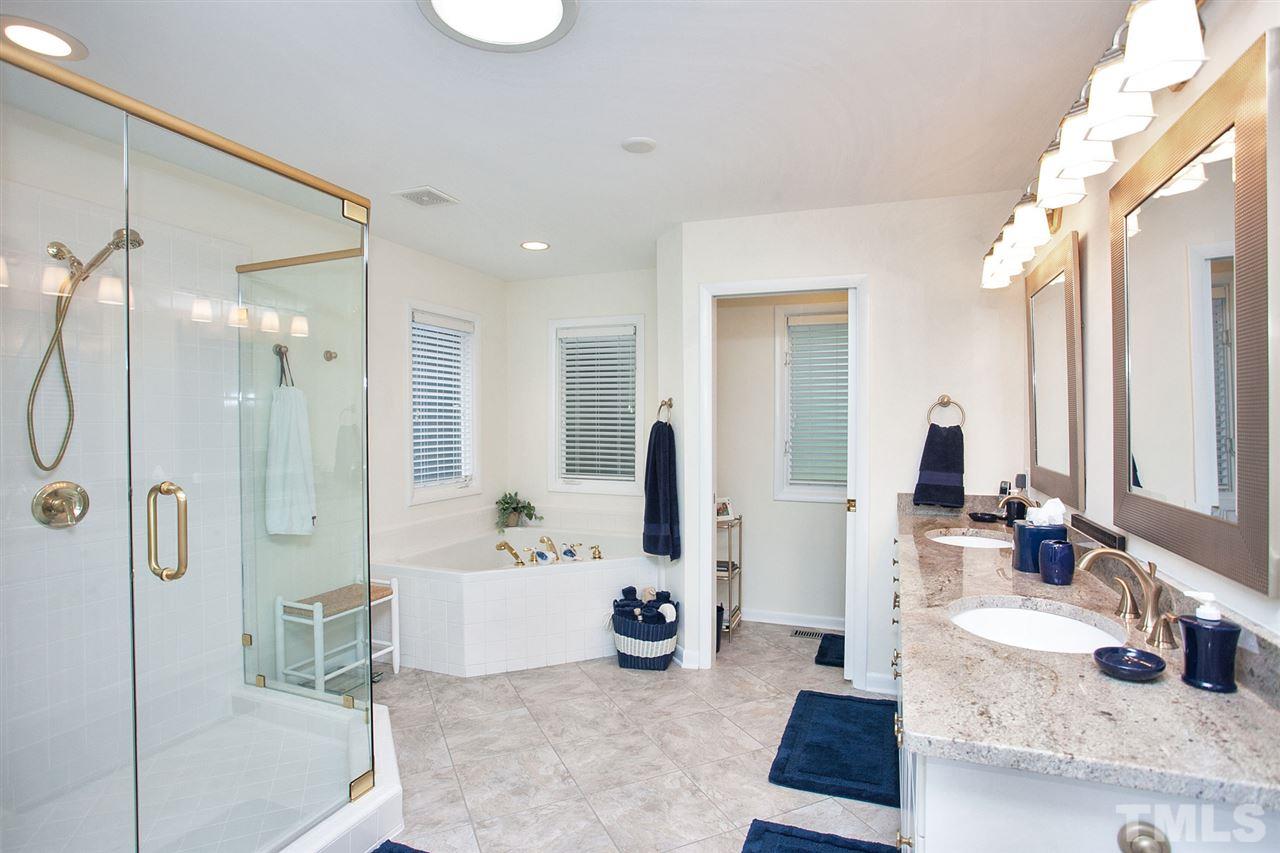 201 Release Circle Raleigh, NC 27615 - Photo 13 of 25 Relax in this updated master spa complete with over-sized shower, jetted tub, dual sink granite vanity, and updated lighting.