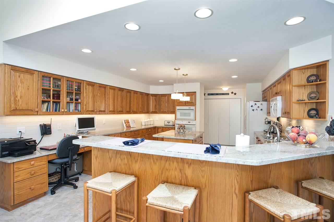 201 Release Circle Raleigh, NC 27615 - Photo 8 of 25 Elegant ceramic tile floor, new granite counters and subway tile backsplash accent this large and functional kitchen.