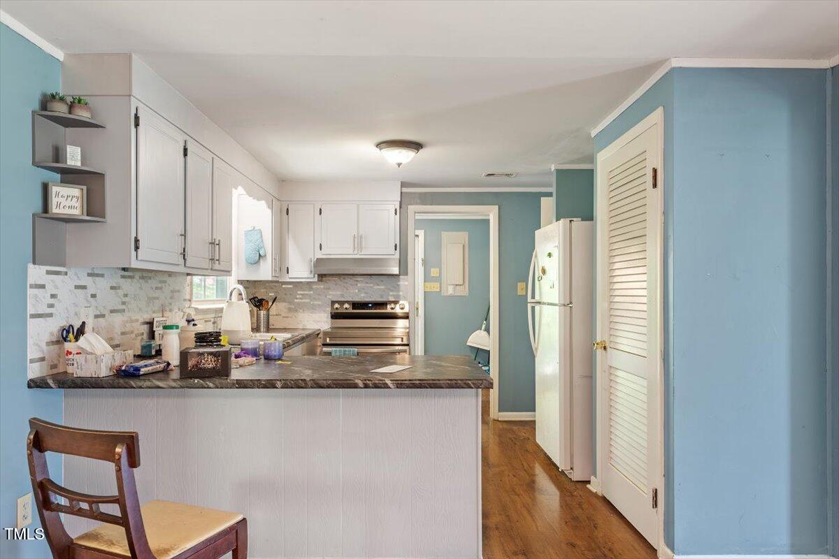 65 Pine View Road Henderson, NC 27537 - Photo 11 of 43 a kitchen with stainless steel appliances granite countertop a refrigerator sink and cabinets