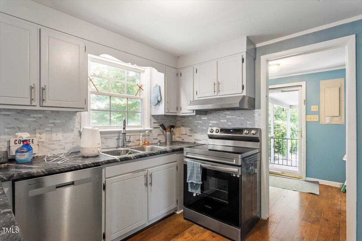 65 Pine View Road Henderson, NC 27537 - Photo 12 of 43 a kitchen with stainless steel appliances white cabinets granite counter tops and a window