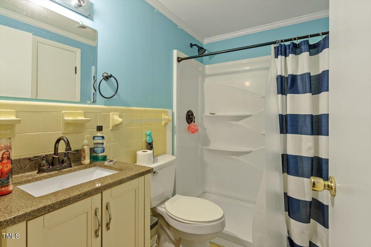 65 Pine View Road Henderson, NC 27537 - Photo 19 of 43 a bathroom with a sink toilet vanity and shower