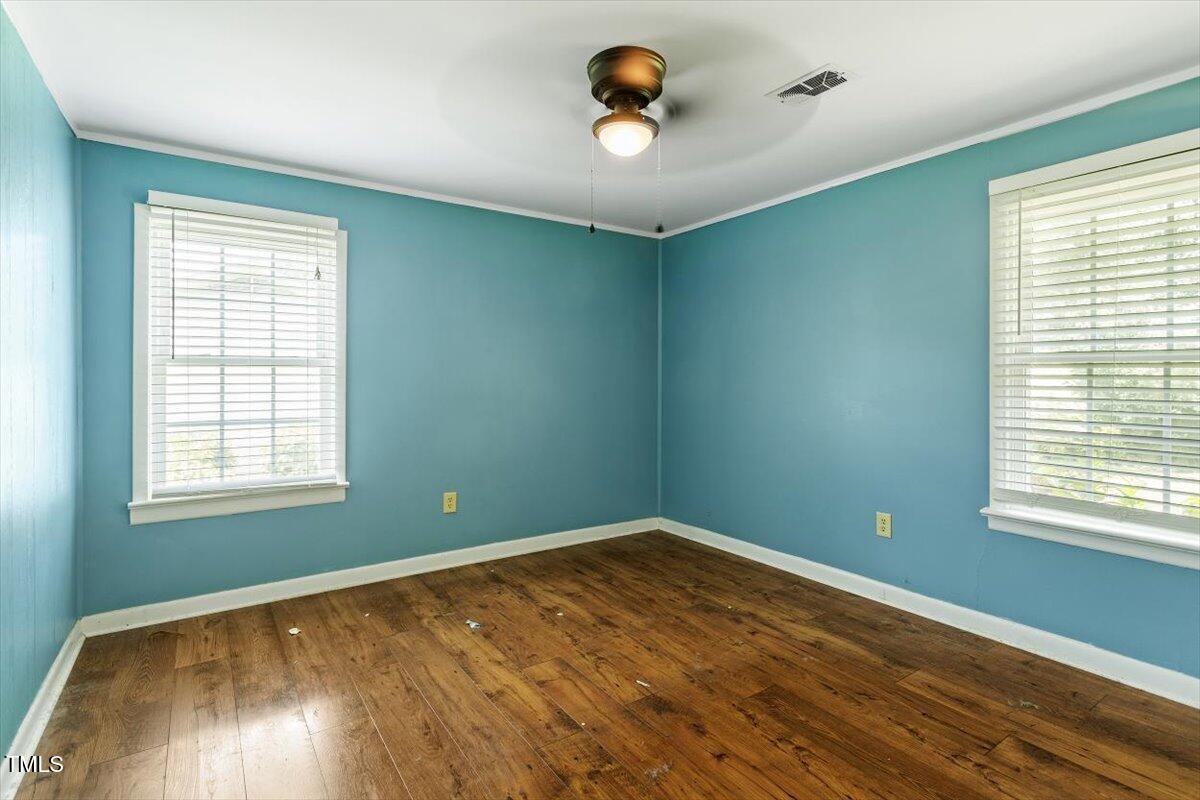 65 Pine View Road Henderson, NC 27537 - Photo 20 of 43 a view of empty room with wooden floor and fan