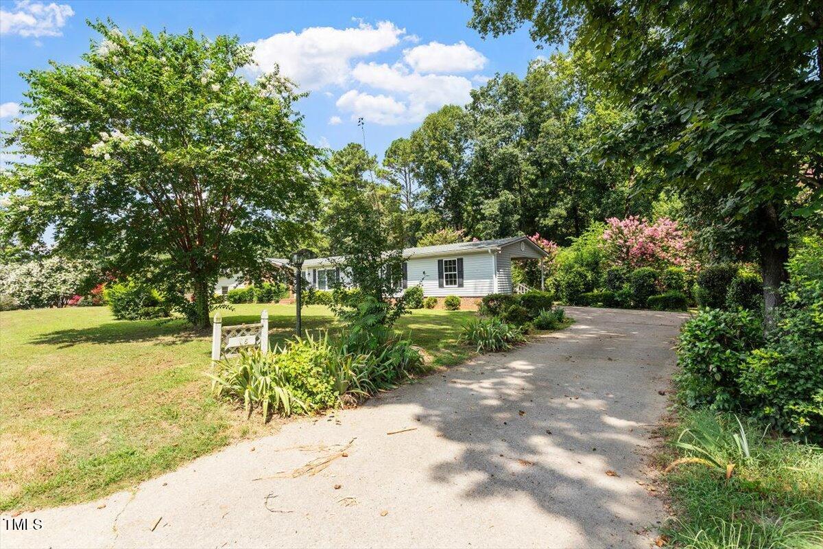 65 Pine View Road Henderson, NC 27537 - Photo 2 of 43 a front view of a house with garden