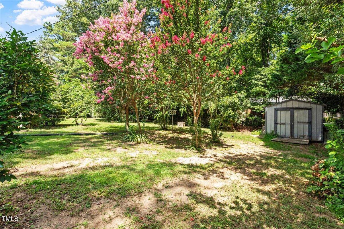 65 Pine View Road Henderson, NC 27537 - Photo 30 of 43 a backyard of a house with a yard and outdoor seating