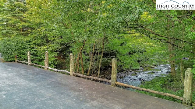 a view of a wooden fence and trees