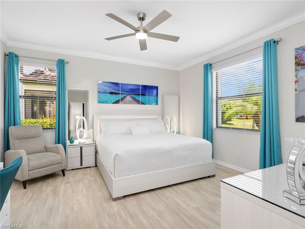 4383 Bismark Way Naples, FL 34119 - Photo 15 of 49 Primary Bedroom with Crown Molding, Pergo Laminate Flooring, Two Windows with Window Coverings, & Brand New Ceiling Fan