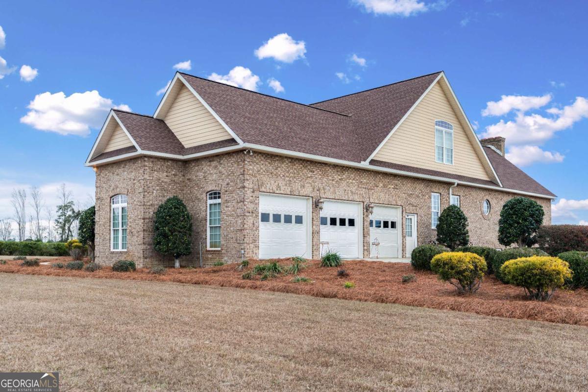 42 Claxton Road Hazlehurst, GA 31539 - Photo 14 of 73 a front view of a house with a yard and garage